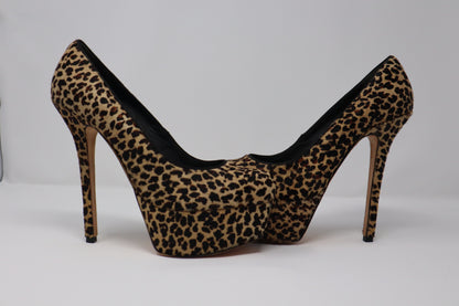 A bold pair of Alice + Olivia by Stacey Bendet platform pumps featuring luxurious pony hair with a striking leopard print. These shoes have a stiletto heel and a platform base, combining both height and comfort, perfect for making a statement with any outfit.