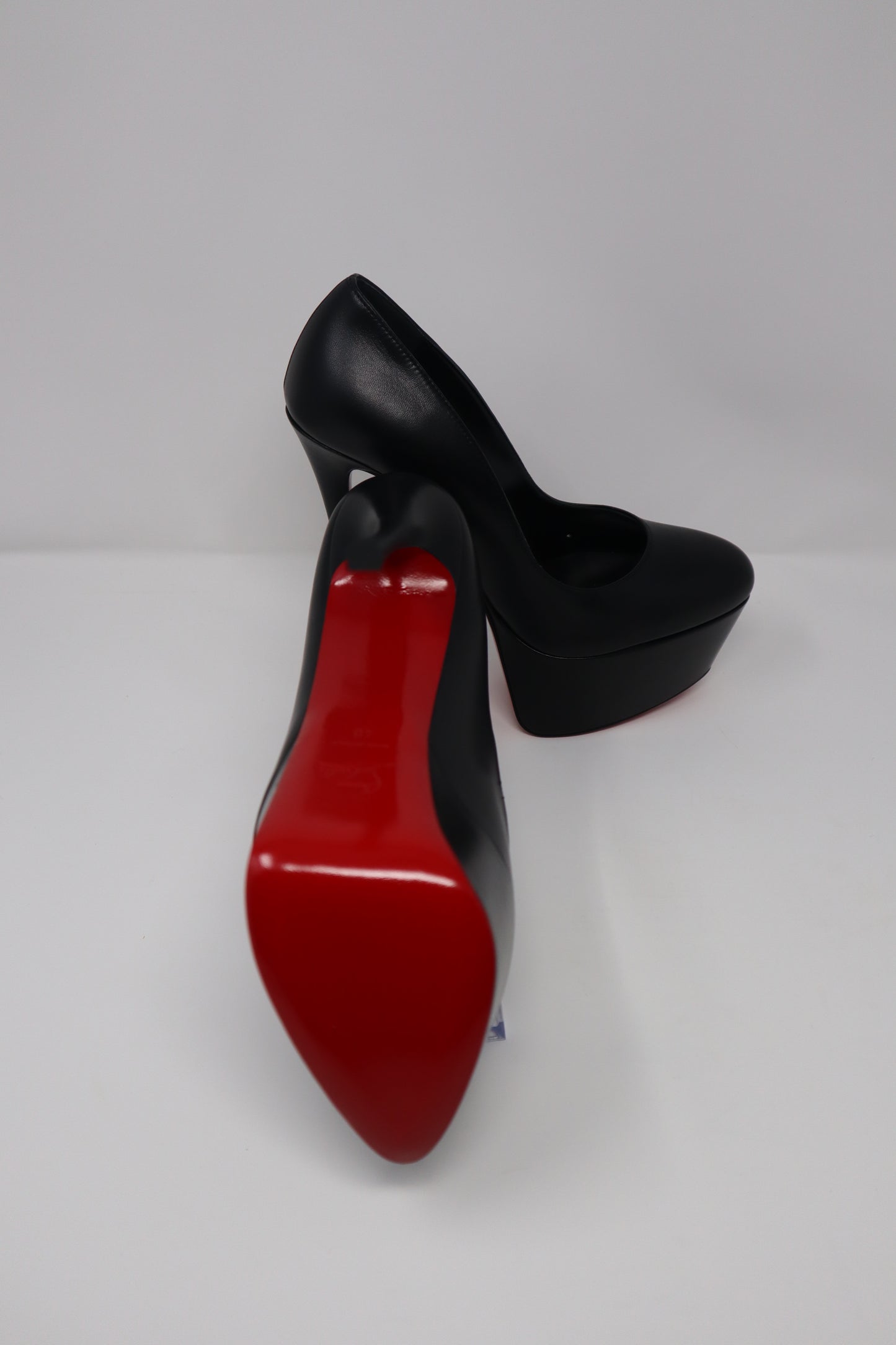 Christian Louboutin Shiny Calfskin Alta Vicky 160 Pumps featuring a towering 160mm platform heel and luxurious shiny calfskin leather with a round toe design. Finished with the iconic red sole for a bold and elegant statement.