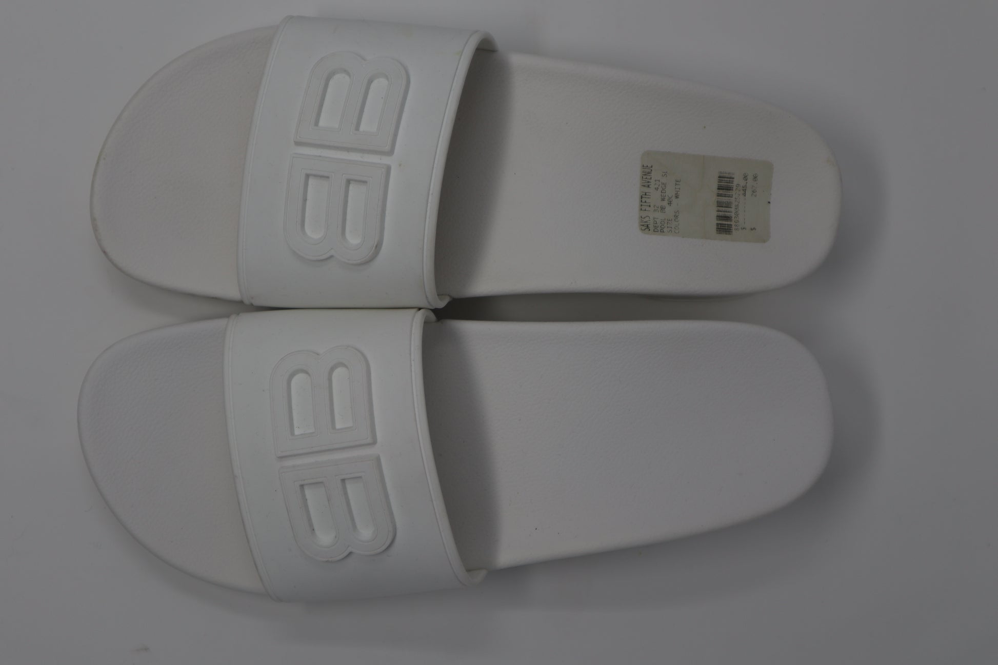 Balenciaga BB Embossed Rubber Slides featuring a wide strap with the iconic embossed BB logo. Made from lightweight, durable rubber with a molded footbed for comfort, these sleek slides offer a minimalist yet luxurious style for casual wear.