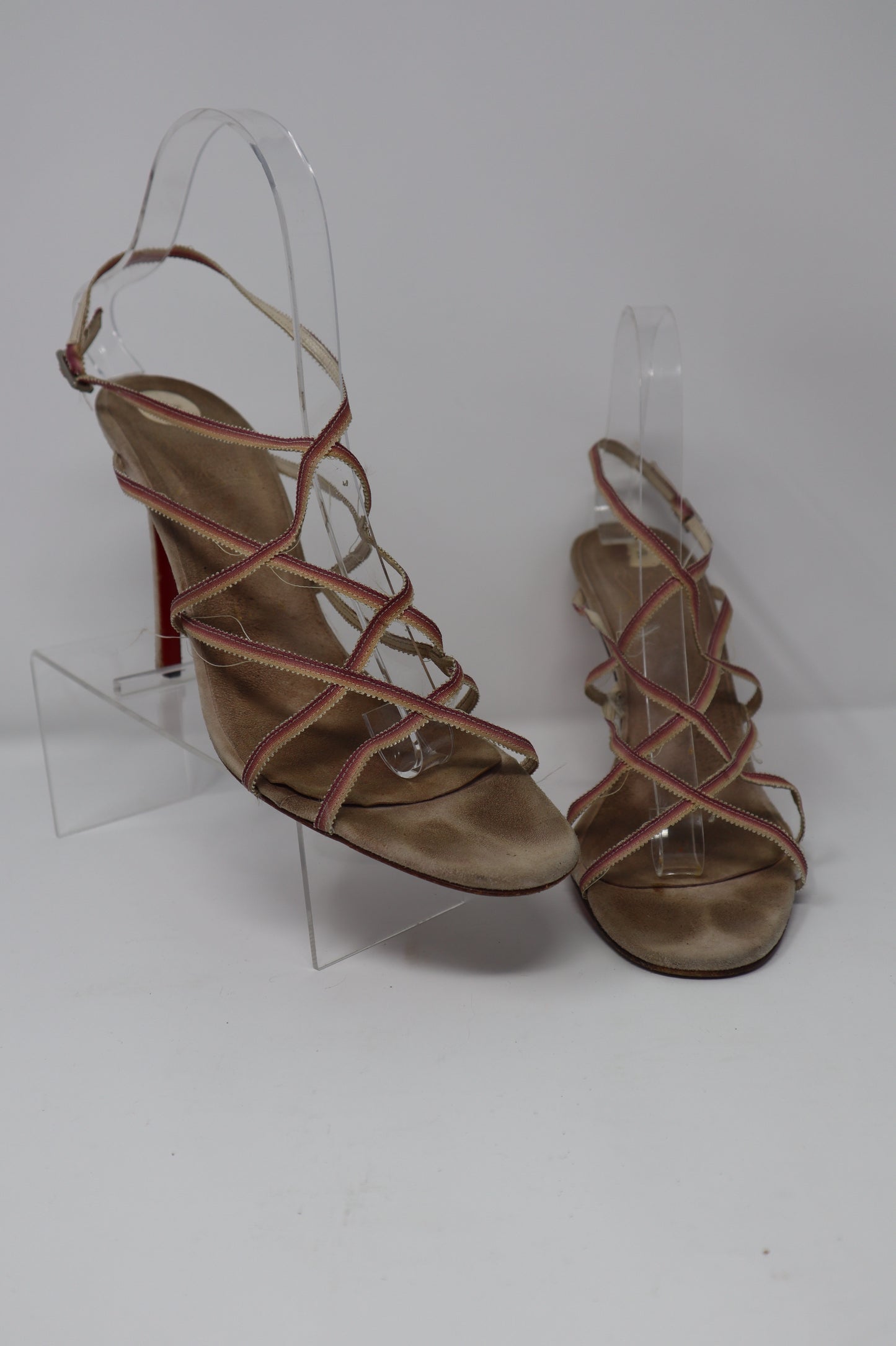 Christian Louboutin Sandals in fair condition, featuring leather straps and the signature red sole. These sandals require new heel taps but retain their elegant, designer appeal.