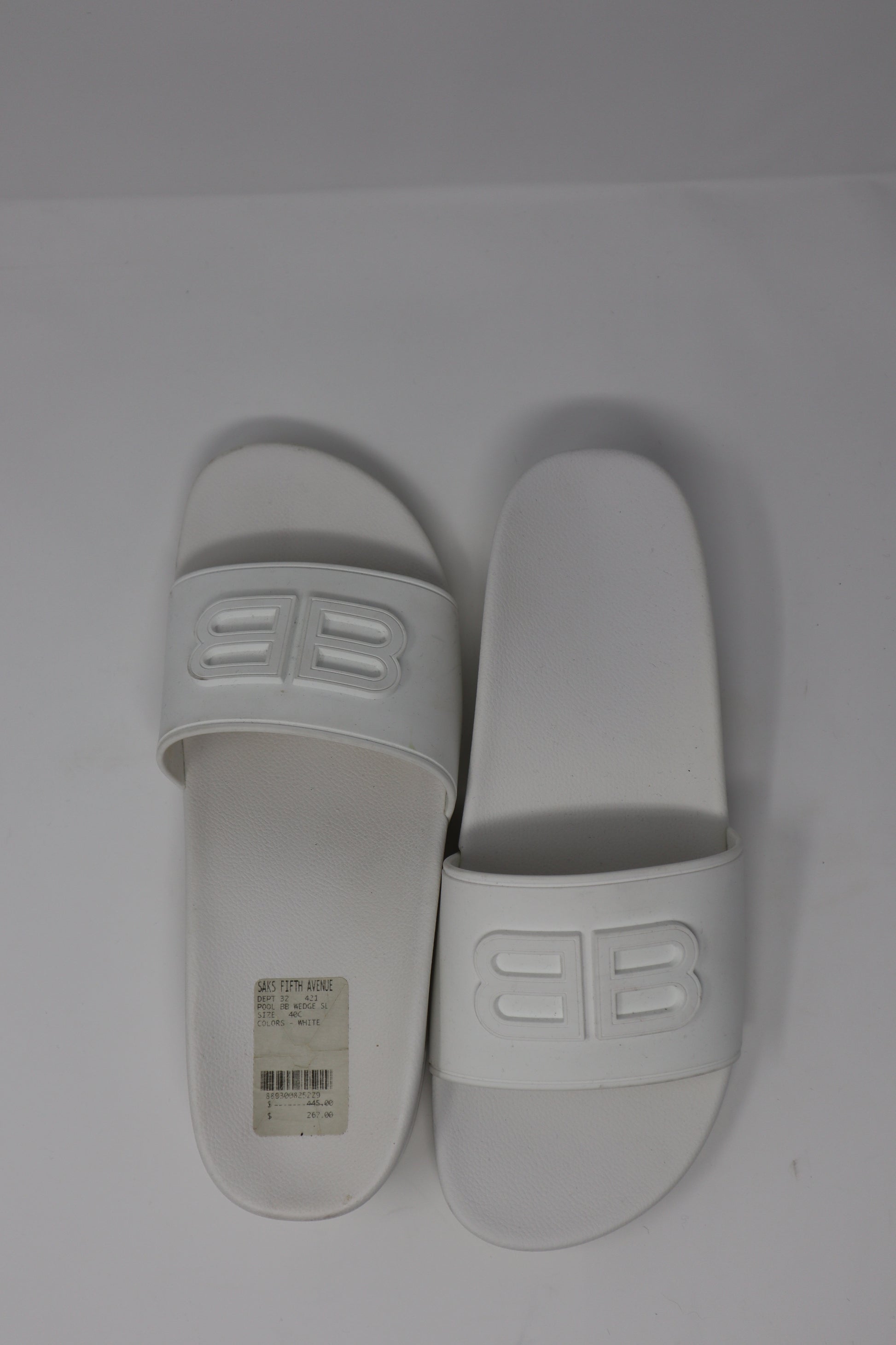 Balenciaga BB Embossed Rubber Slides featuring a wide strap with the iconic embossed BB logo. Made from lightweight, durable rubber with a molded footbed for comfort, these sleek slides offer a minimalist yet luxurious style for casual wear.