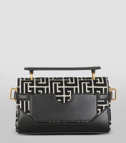 Balmain Monogram B-Buzz 19 Shoulder Bag featuring a monogram leather design with gold-tone BB logo hardware. A compact, elegant shoulder bag perfect for day or evening wear. Retail price $1,795, available for $850.