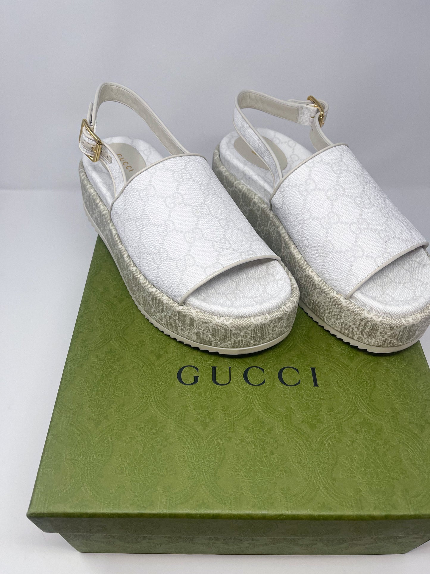 A luxurious pair of GG Supreme Monogram Angelina Platform 35mm Slingback Sandals in size 40. These designer sandals feature the iconic GG monogram pattern, a platform sole, and an elegant slingback design. Originally priced at $1300, they are now available for $300. The image highlights the intricate details and high-end craftsmanship, showcasing the perfect blend of luxury and comfort.