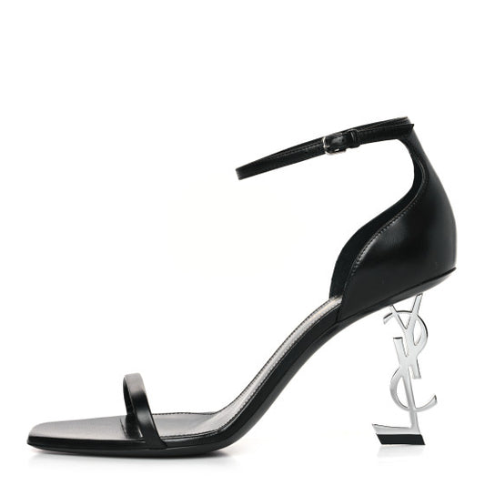 Saint Laurent Calfskin Opyum 85 Sandals, designed with smooth calfskin leather, featuring a sleek stiletto heel with the iconic YSL logo, and a minimalist ankle strap for an elegant and modern silhouette.